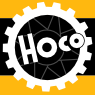 Historisches HOCO-Logo von 1971 in Schwarz, Weiß und Gelb mit Zahnradmotiv